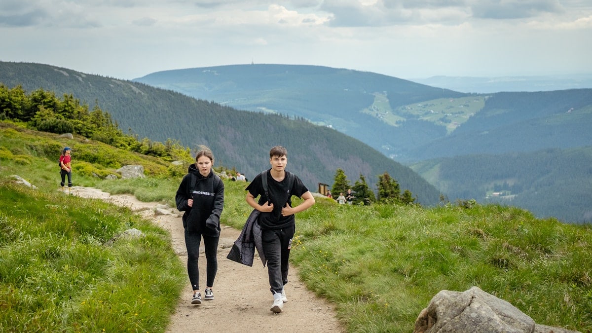 Two people hiking on a mountain trail